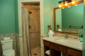 A bathroom with a shower, toilet, and sink. - Large Oceanfront Villa with Pool, Close to Village (Placencia)