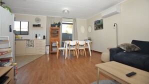A compact living space with a kitchen, dining area, and a living room. - Relaxed, beachy 2 bed apartment, only 1.9kms from the beach, close to shops (Kingscote)