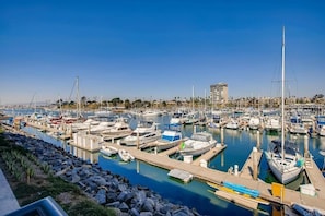 A marina with numerous boats docked at various piers.