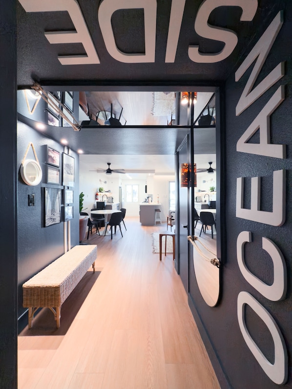 A modern interior with a dark wall and large white letters spelling "OCEAN".