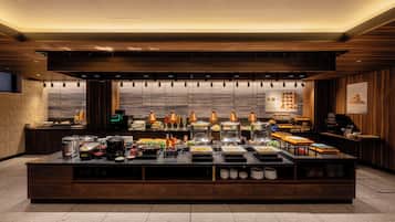 A buffet setup with various food items and utensils.