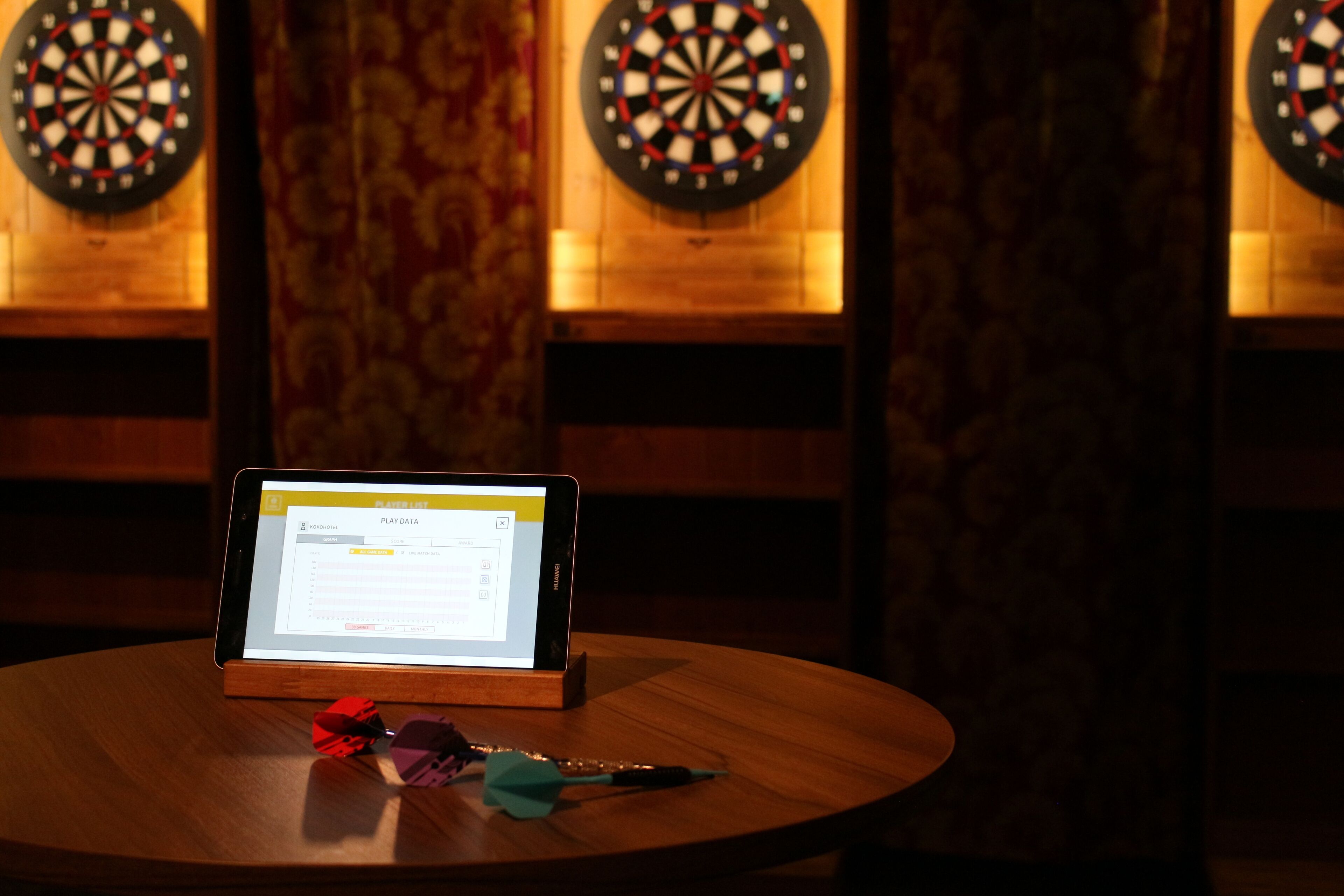 A dartboard with a dartboard and a dart on a table.
