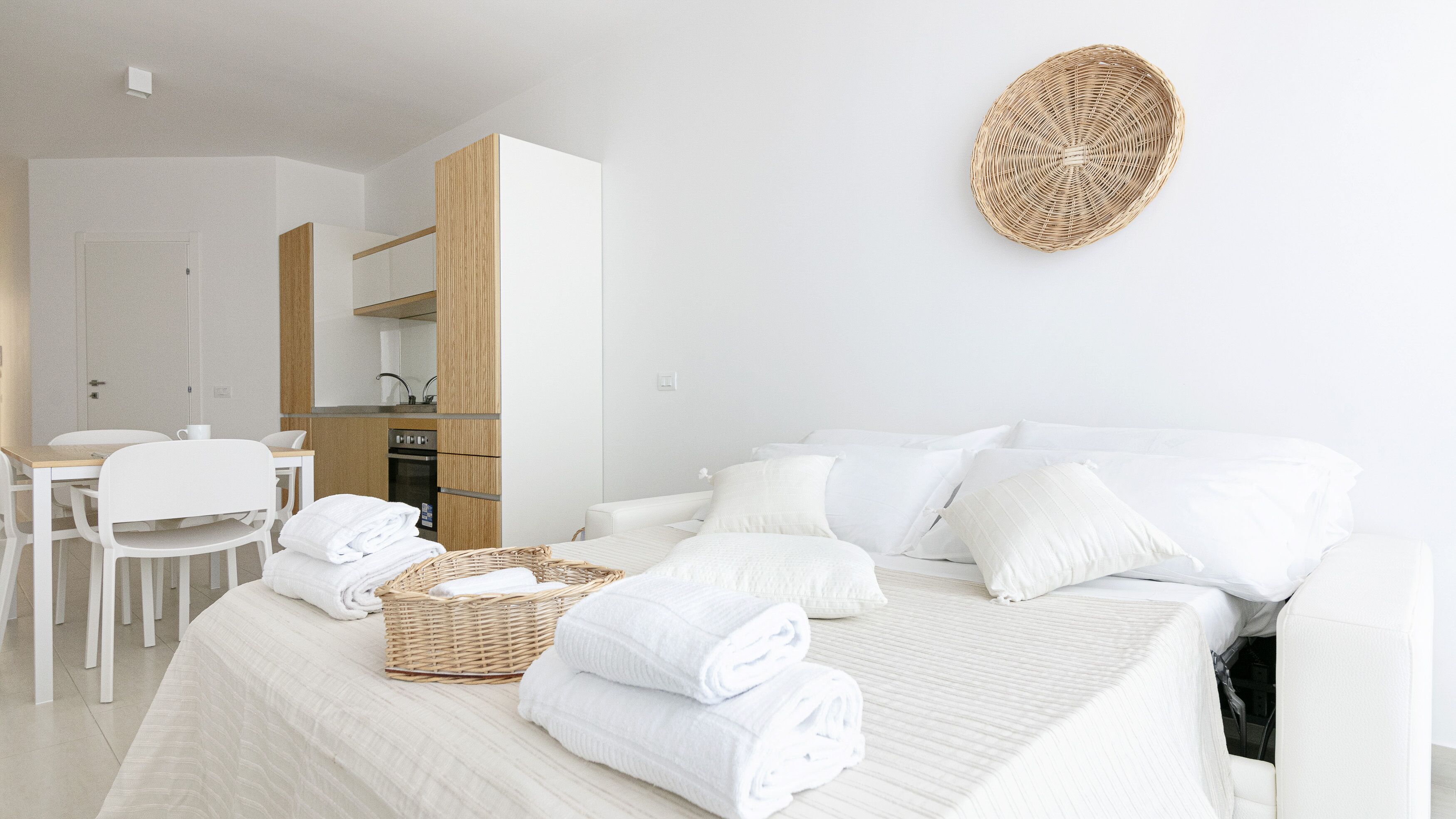 Una habitación de hotel con cama, zona de comedor y kitchenette.