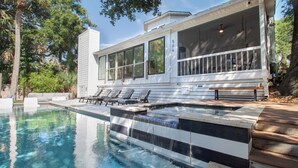 A modern house with a swimming pool, outdoor seating, and a covered porch. - Newly Renovated 1 Block from Beach w/Pool!~The Jolly Folly (Folly Beach)