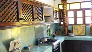 A kitchen with a stove, sink, and cabinets. - Malaika House (Malindi)