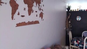 A living room with a world map on the wall, a purple sofa, and a dining area with a table and chairs. - Home Sweet Home - Entire Apartament (Ovar)