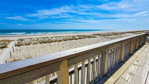 A wooden boardwalk leading to a beach with sand dunes and ocean views. - Queen's Grant E-117 – Perfect Beach Getaway (Topsail Beach)