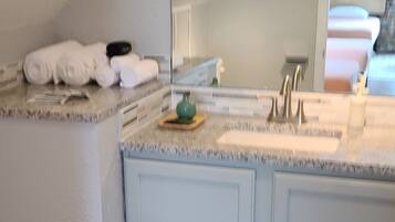 Combined shower/tub, hair dryer, towels, soap