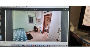 A room with a bed, a desk, and a small window. - Har nof penthouse (Jerusalem)