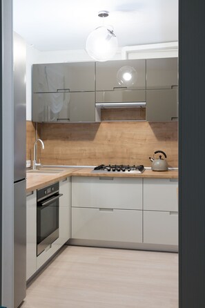 Design Apartment | Private kitchen | Full-size fridge, microwave, oven, stovetop - PaulMarie Apartments on Kozhara 12 (Gomel)