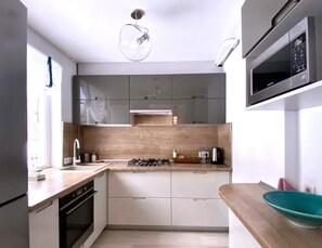 Design Apartment | Private kitchen | Full-sized fridge, microwave, oven, stovetop - PaulMarie Apartments on Kozhara 12 (Gomel)