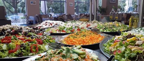 A buffet with various salads and dishes.