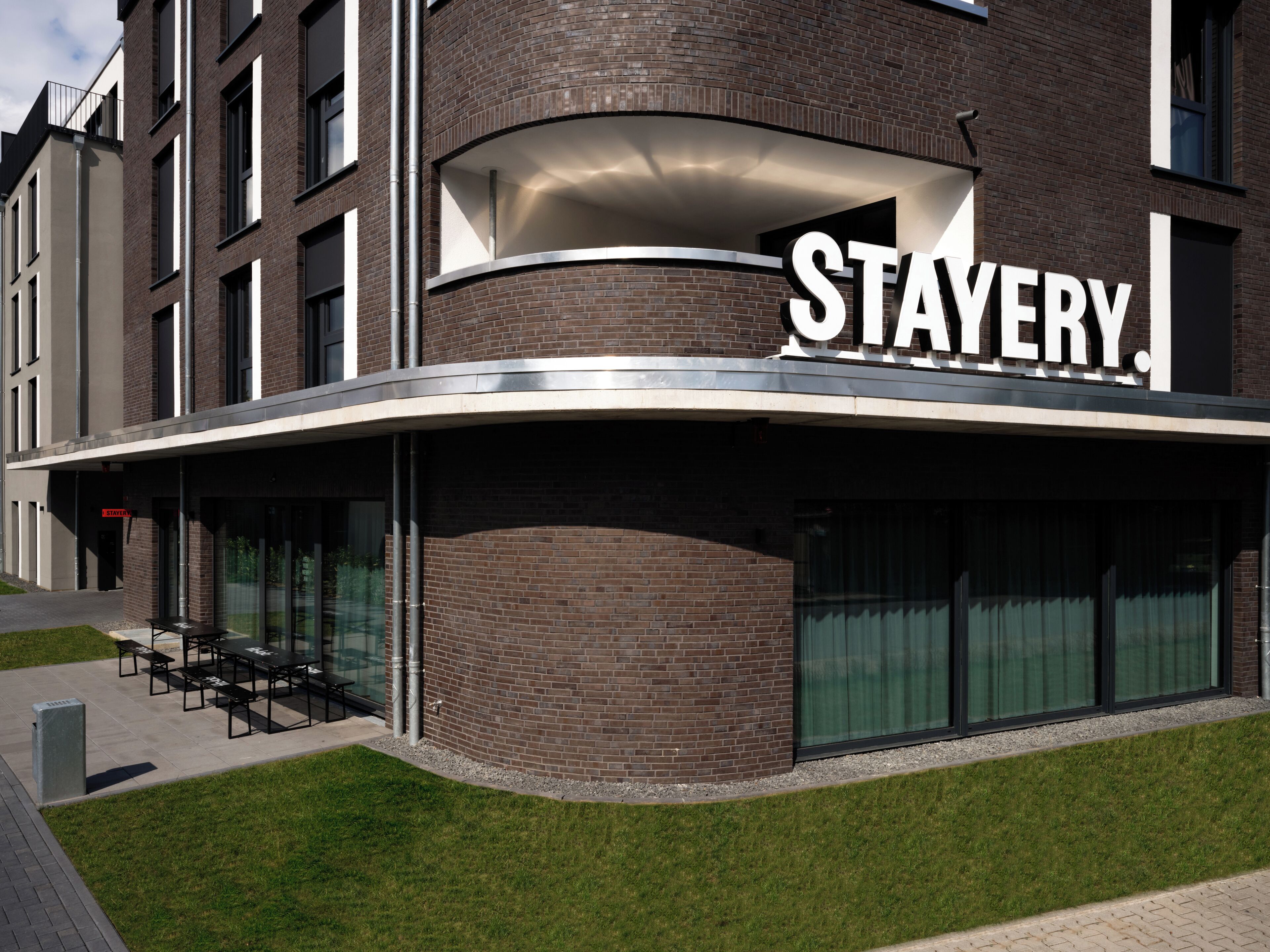 A building with a curved facade and the word "STAYERY" prominently displayed.