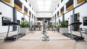 A modern indoor gym with treadmills, exercise equipment, and potted plants. - Anda Bangkok Hotel (Bangkok)