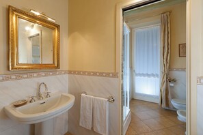A bathroom with a sink, mirror, and toilet.