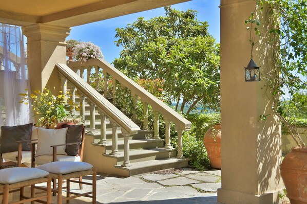 A stone staircase leading to a balcony with outdoor seating and potted plants. - VILLA WITH A POOL IN THE TUSCAN HILLS (CASCIANA TERME LARI)