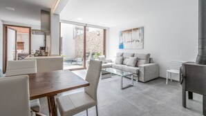 A modern living room with a dining area, a sofa set, and a fireplace. - Pollensi, Adosado 5StarsHome Mallorca (Pollensa / Pollença)