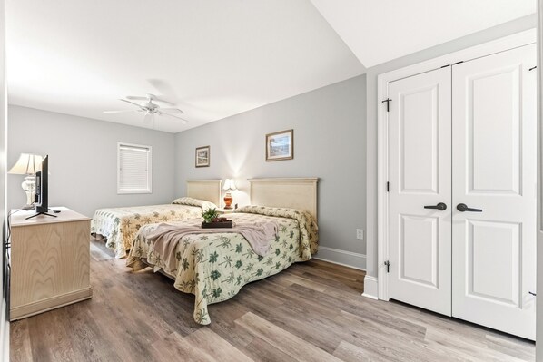 A bedroom with two beds, a ceiling fan, a desk with a lamp, and a wardrobe. - Mar Vista Grande 515-3BR/3BA Oceanfront condo in Ocean Dr. (North Myrtle Beach)