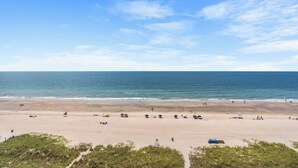 A beach with a clear sky, sandy shore, and a few umbrellas and beach chairs. - North Shore Villas 903-3BR/3BA Oceanfront-Ocean Drive (North Myrtle Beach)