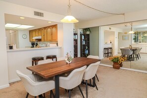 Enjoy meals in this stylish dining area with a wooden table and comfortable chairs.