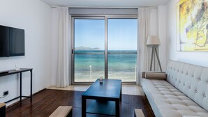 A modern living room with a large sliding glass door leading to a balcony with a view of the sea. - YourHouse Blaublue 2.3, wonderful sea view apartment in Majorca North (Can Picafort)