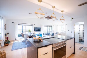 Enjoy a spacious living area with a central kitchen island and stove, perfect for cooking and socializing.