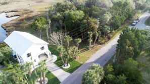 Stunning two-story home surrounded by lush greenery and a large front porch.
