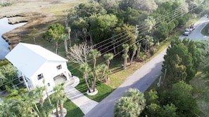 Stunning two-story home surrounded by lush greenery and a large front porch.