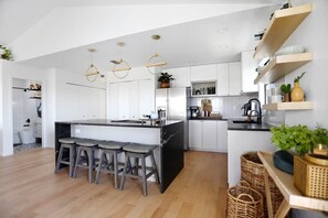 Enjoy cooking in this kitchen with a central island, bar stools, and ample storage.