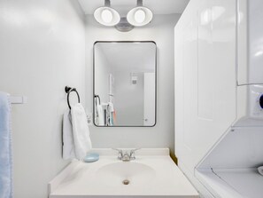 Bathtub, hair dryer, towels, soap