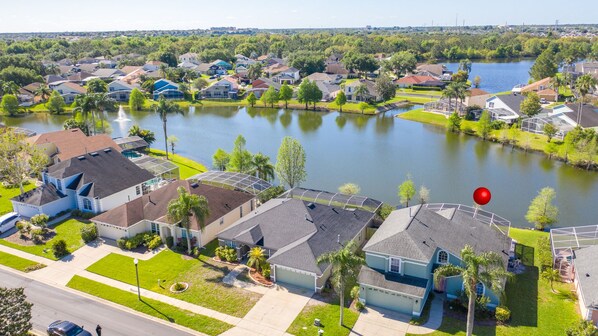 A residential area with houses, a lake, and a golf course.