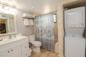 Bathtub, hair dryer, towels, soap