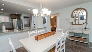 A modern kitchen with white cabinetry, a built-in oven, and a stainless steel refrigerator. - Ocean Village Club Condo P18 (St. Augustine)