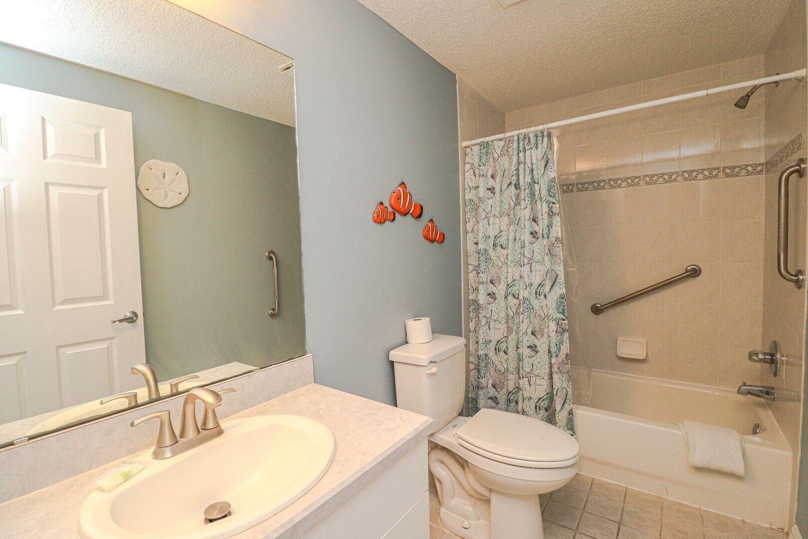 A bathroom with a sink, toilet, and shower.