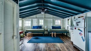 A compact, well-lit room with two beds, a kitchenette, and a ceiling fan. - Bluff`s Charm 3 bedroom lake home on Keuka Lake (Penn Yan)