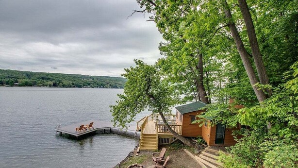 A lakeside cabin with a dock, outdoor seating, and a fire pit. - Bluff`s Charm 3 bedroom lake home on Keuka Lake (Penn Yan)