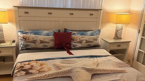 A bedroom with a bed, nightstands, a lamp, and a window with curtains. - Canal View Summer Escape With Dock, Hot Tub and Cabana Club Access (Key Colony Beach, Marathon)