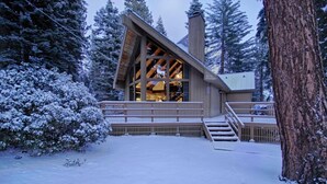 A modern wooden cabin with a sloped roof, large windows, and a wooden deck. - Rim Drive Lookout (Tahoe Vista)