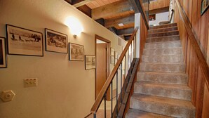 A staircase with wooden railings and carpeted steps leading to an upper floor. - Vidor Village (Kings Beach)
