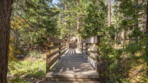 A wooden bridge in a forested area. - Vidor Village (Kings Beach)