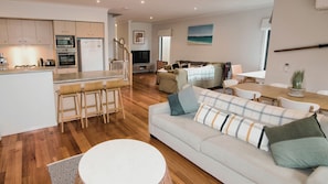 A modern apartment with a kitchen, dining area, and living room.