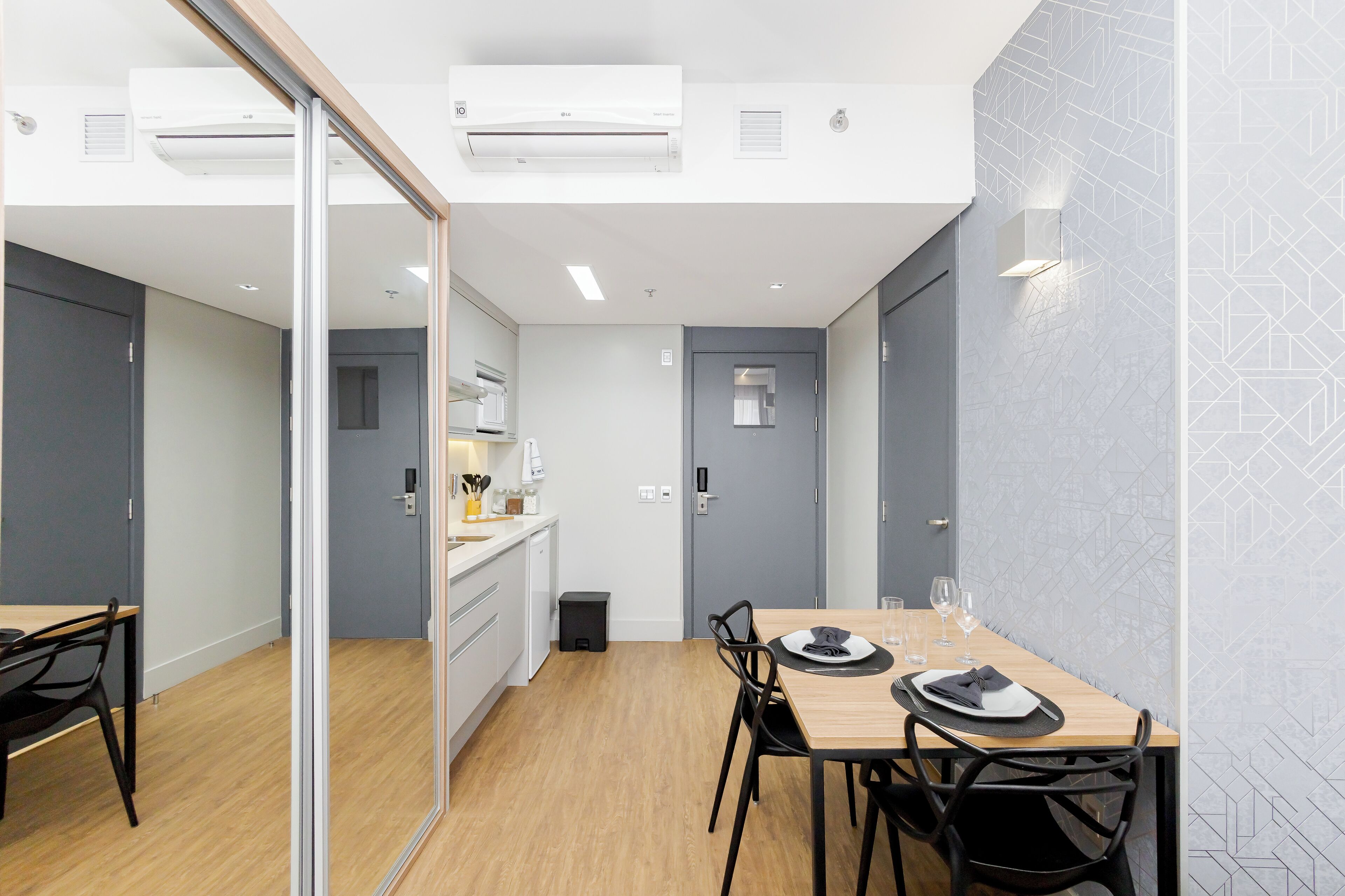 A modern kitchen with white cabinets, a wooden countertop, and a built-in oven.