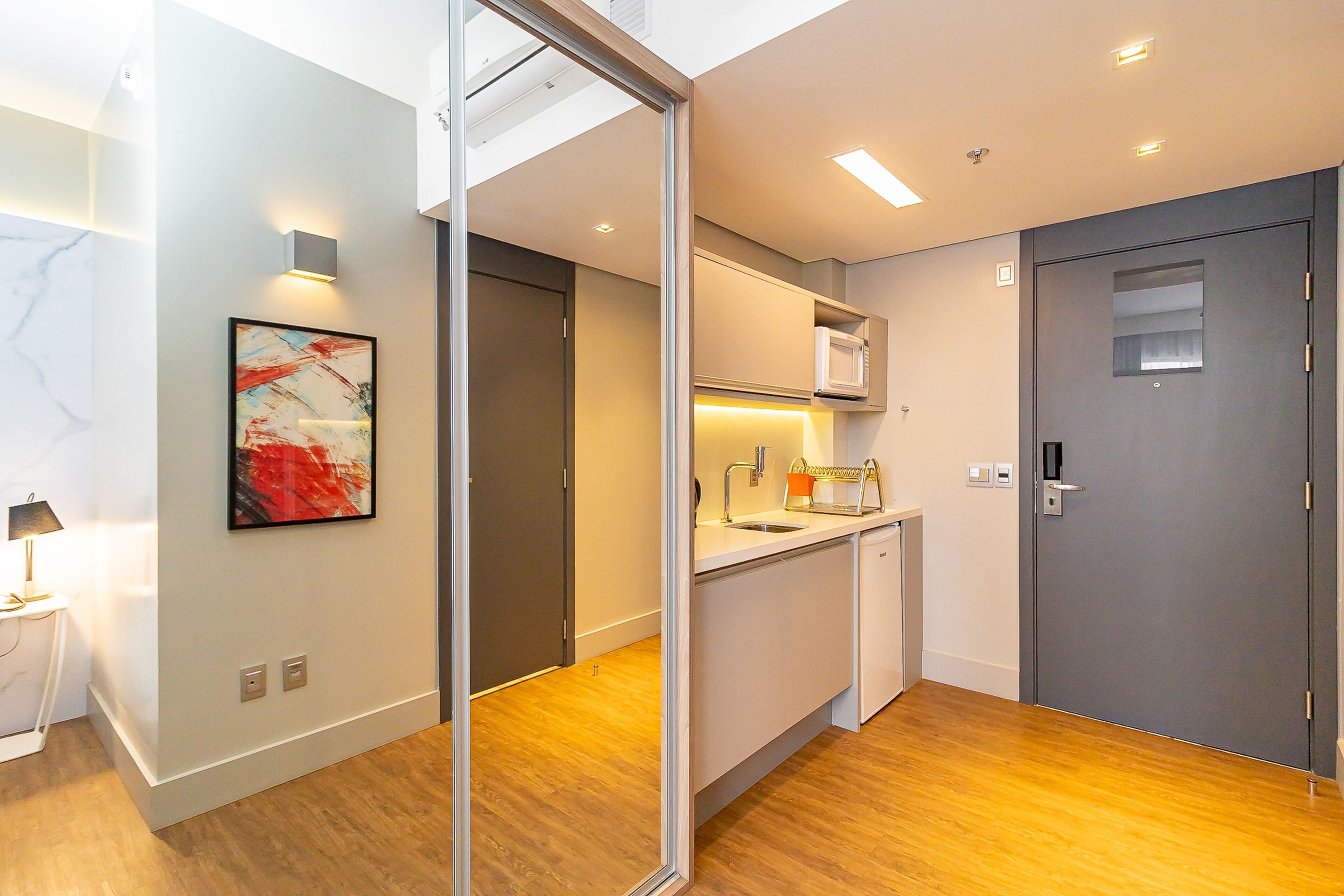 A modern kitchen with a built-in microwave, a sink, and a countertop.