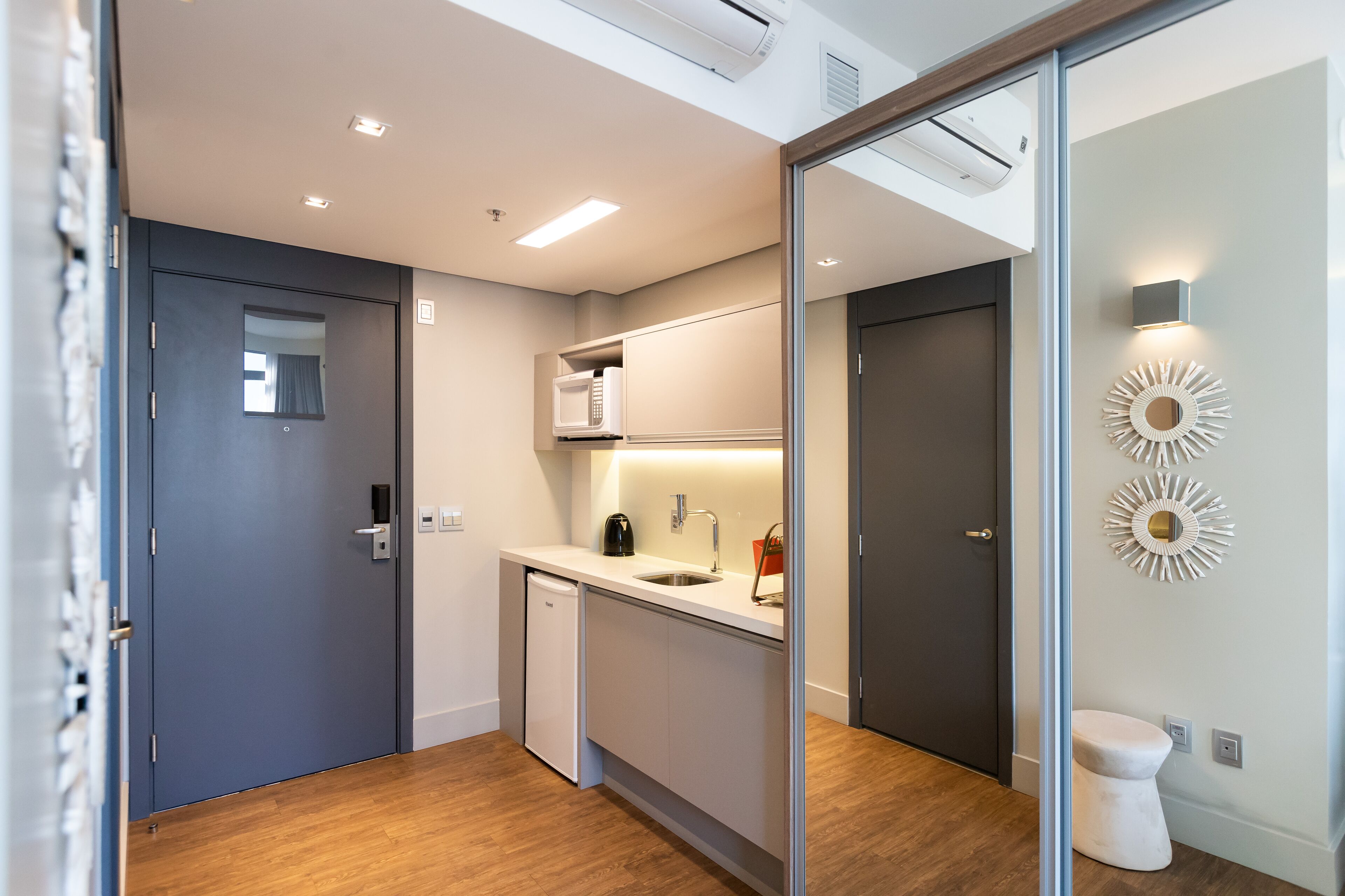 A modern kitchen with a microwave, sink, and coffee maker.