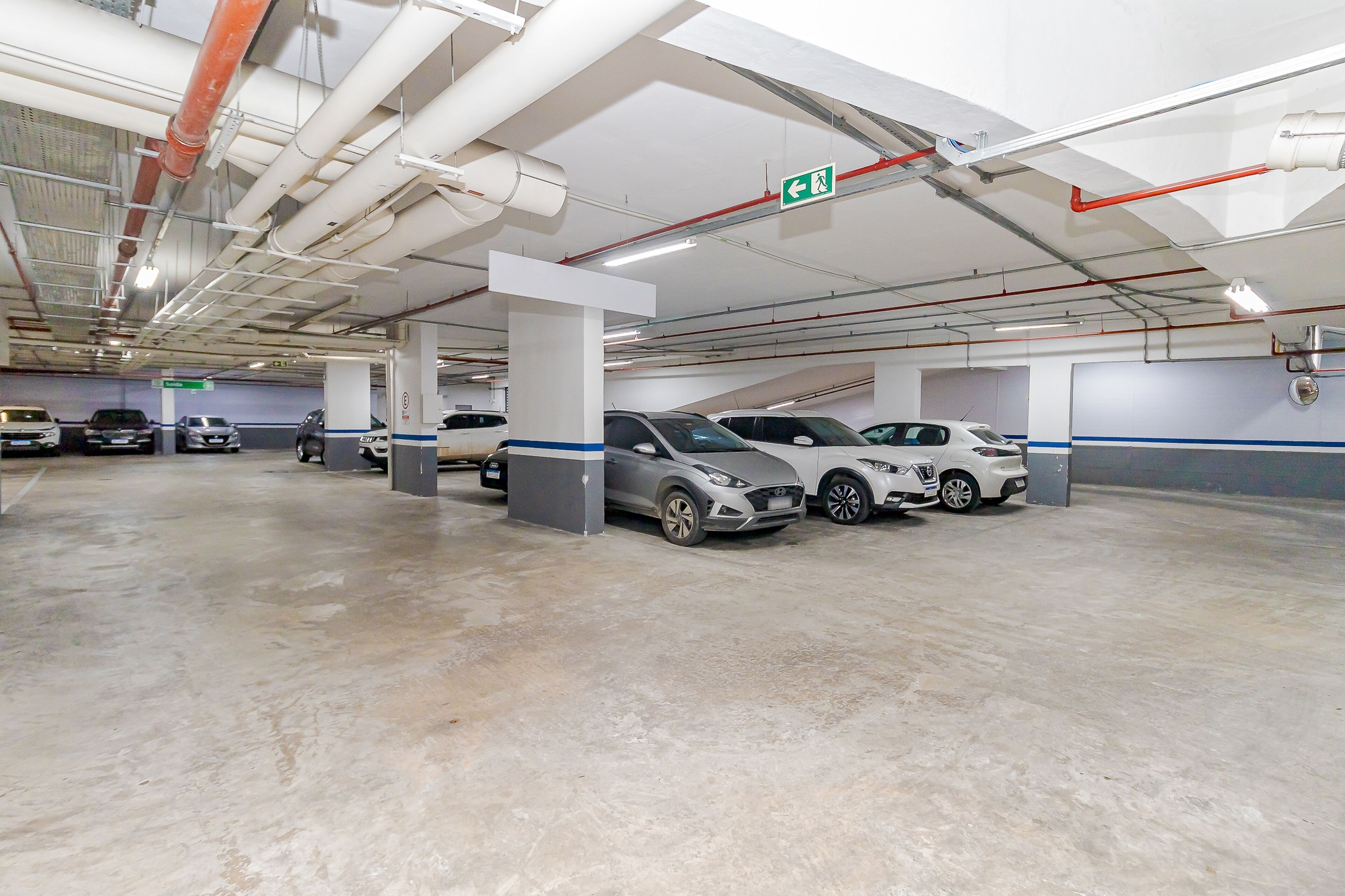 A multi-level parking garage with several cars parked.