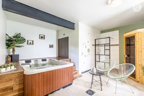 Bathroom features a bathtub and a wooden vanity.