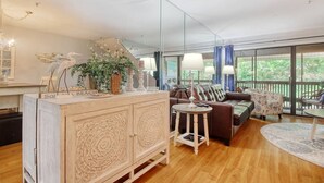 A spacious living area with a wooden cabinet, a sofa, and a coffee table. - LakeViews-Quaint/Quiet-Wlk 2 Beach-Kingston Plantation-Gated Community (Myrtle Beach)