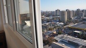 Un immeuble de grande hauteur, doté de nombreux étages, de grandes fenêtres et offrant une vue sur un paysage urbain composé de différents bâtiments et d’un ciel dégagé.