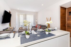 City Apartment | Living area | 42-inch Smart TV with cable channels, TV - The Gallery by Riviera Rentals (Playa del Carmen)