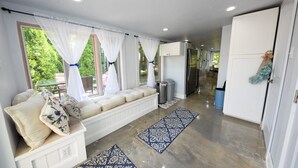 A modern kitchen with a built-in bench, white cabinets, and a stainless steel refrigerator. - Spring and Summer are on the way! Book your stay Today! (West Cape May)